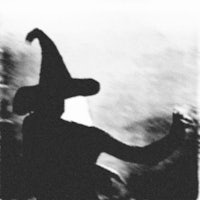 a silhouette of a woman in a witch hat